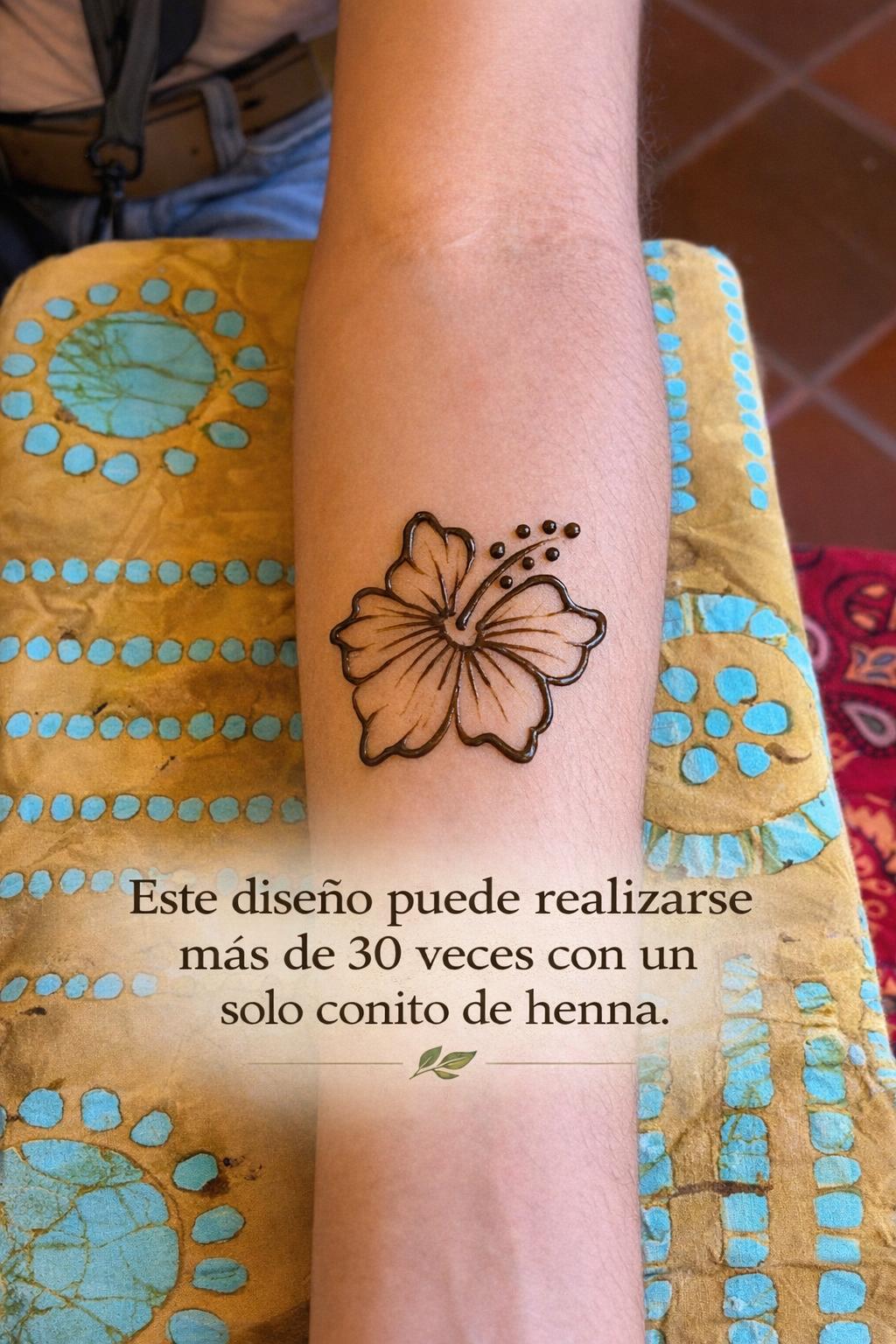 Henna tattoo of a maga flower on a person's arm with text.