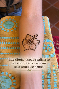 Henna tattoo of a maga flower on a person's arm with text.